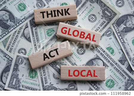 Think global act local symbol. Wooden blocks with words Think global act local. Beautiful dollar background. Business and Think global act local concept. Copy space. Think global act local symbol. Wooden blocks with words Think global act local. Beautiful dollar background. Business and Think global act local concept. Copy space. 111958962