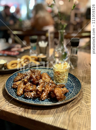 Teriyaki chicken wings under cherry souse with sesame seeds and pickled cabbage Teriyaki chicken wings under cherry souse with sesame seeds and pickled cabbage 111959326