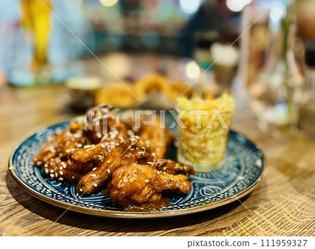 Teriyaki chicken wings under cherry souse with sesame seeds and pickled cabbage Teriyaki chicken wings under cherry souse with sesame seeds and pickled cabbage 111959327