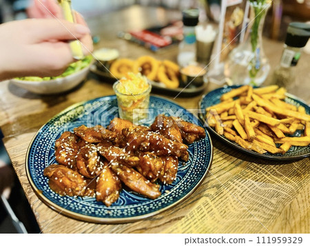 Teriyaki chicken wings under cherry souse with sesame seeds and pickled cabbage Teriyaki chicken wings under cherry souse with sesame seeds and pickled cabbage 111959329