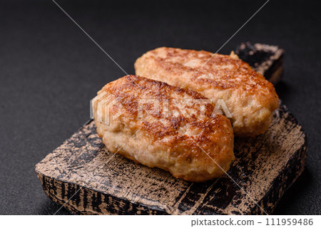 Delicious fresh fried minced fish cutlets with spices and herbs Delicious fresh fried minced fish cutlets with spices and herbs 111959486