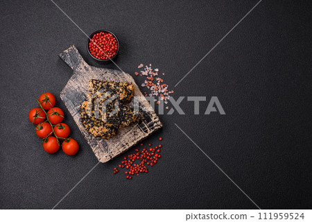Delicious fresh crispy chicken or fish nuggets on a dark concrete background 111959524