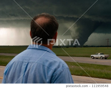 Man looks at the tornado in front of him Man looks at the tornado in front of him 111959548