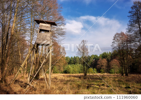 Photo of an elevated deer hunting blind by the woods. 111960060
