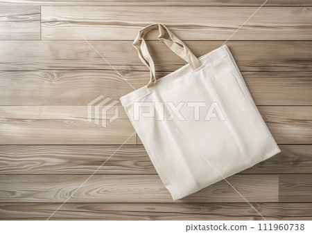 Advertising shot, white beige linen shopper, shopping bag hanging on a hook on light wooden wall 111960738