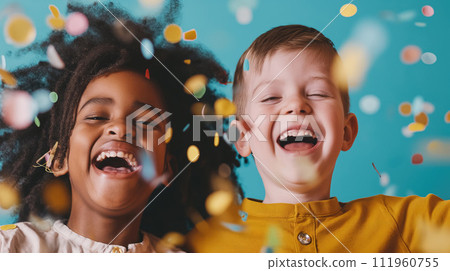 Portrait of two boys laughing together, children of different nationalities in t-shirts, with short hair, and dreadlocks posing and laughing together at a holiday party with confetti on pink Portrait of two boys laughing together, children of different nationalities in t-shirts, with short hair, and dreadlocks posing and laughing together at a holiday party with confetti on pink 111960755
