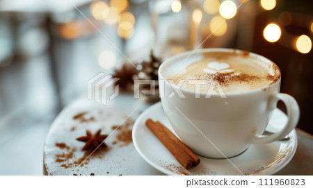 White cup of aromatic cappuccino coffee with cinnamon, on wooden table in a cafe with cozy interior with lamps at the background White cup of aromatic cappuccino coffee with cinnamon, on wooden table in a cafe with cozy interior with lamps at the background 111960823