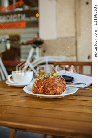 With croissants and coffee on the cafe's summer terrace 111960935