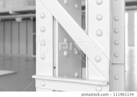 Vintage industrial architecture details, close-up photo of a white steel truss pillar Vintage industrial architecture details, close-up photo of a white steel truss pillar 111961134