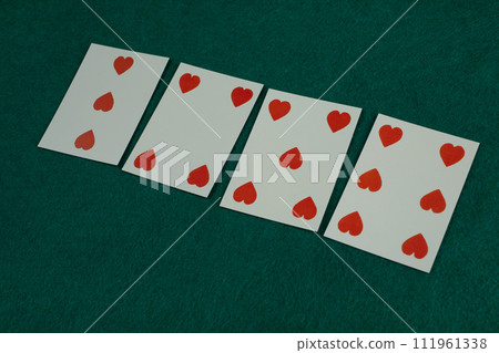 Old west era playing card on green gambling table. 3,4,5,6 of hearts. 111961338