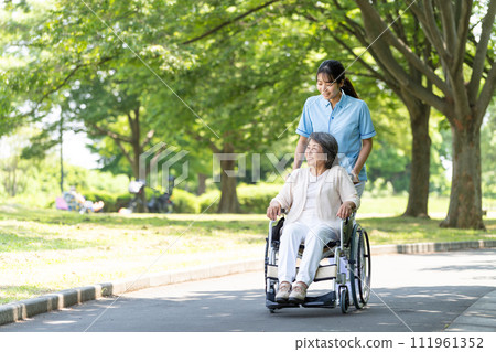 Senior woman in wheelchair and young woman caregiver 111961352