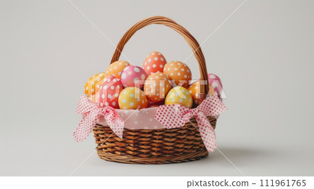 Easter eggs in a basket with a bow, isolated on a white background 111961765
