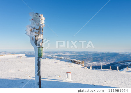 Tourist signposts on Snezka,  mountain on the border between Czech Republic and Poland, Krkonose mountains, winter morning 111961954