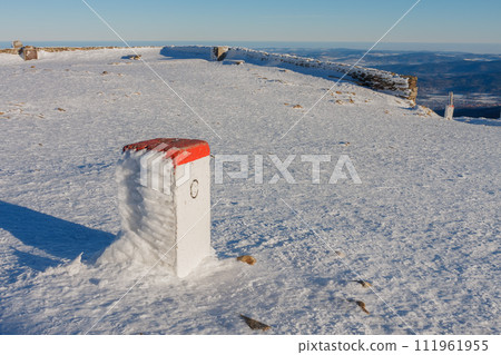 Boundary stone on Snezka, mountain on the border between Czech Republic and Poland, Krkonose mountains, winter morning 111961955
