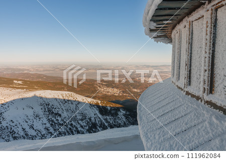 Winter morning, a part of  disc shaped meteorological observatory, city Karpacz view from Snezka , mountain on the border between Czech Republic and Poland. 111962084