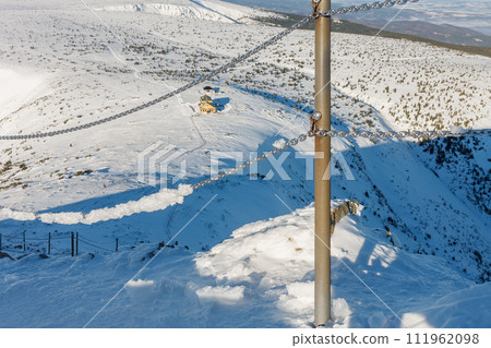 Winter morning, danger path from Snezka to Silesian house, krkonose mountains. The path is secured with a railing of chains. 111962098
