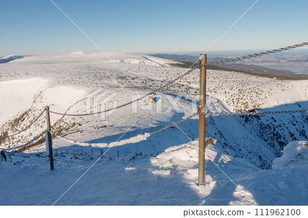 Steel railing tube with a chain on danger path from Silesian house to Snezka, mountain on the border between Czech Republic and Poland. 111962100