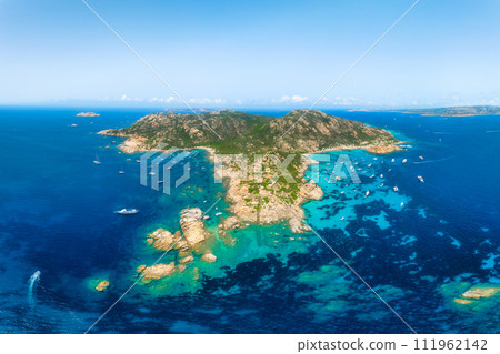 An island in the middle of the sea. Drone view of a yachts, boats and island. 111962142