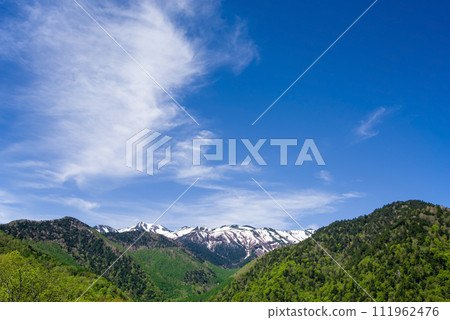 從上高地乘鞍超級林道看到殘雪的乘鞍山和鮮綠的山脈 111962476