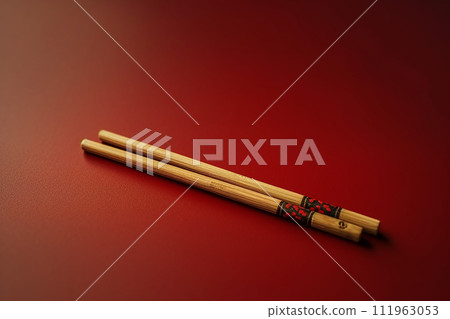 Elegant Chopsticks Resting on a Vibrant Orange Background Elegant Chopsticks Resting on a Vibrant Orange Background 111963053