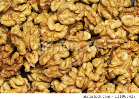 Walnuts background. Kernels walnuts. Top view. Vegetarian or healthy food Walnuts background. Kernels walnuts. Top view. Vegetarian or healthy food 111963422