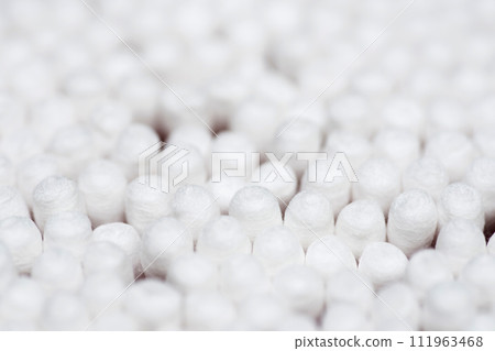 Many white cotton sticks. Round container with cotton buds Many white cotton sticks. Round container with cotton buds 111963468