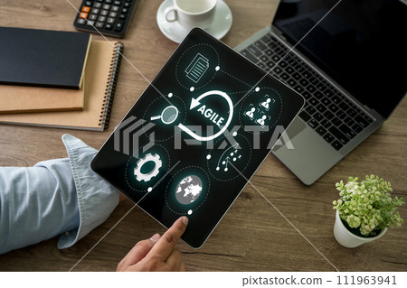 A businessman using a laptop computer Agile management and the principles of agile software development 111963941