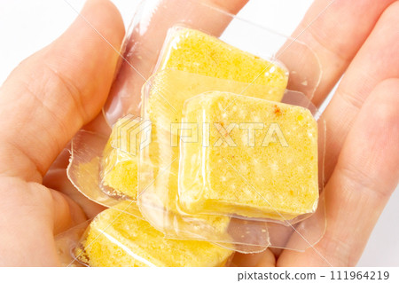 Soup cubes in hand. Yellow soup cubes. Soup cubes in hand. Yellow soup cubes. 111964219