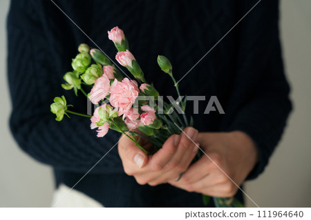 Close-up of woman's hand holding a bouquet Close-up of woman's hand holding a bouquet 111964640
