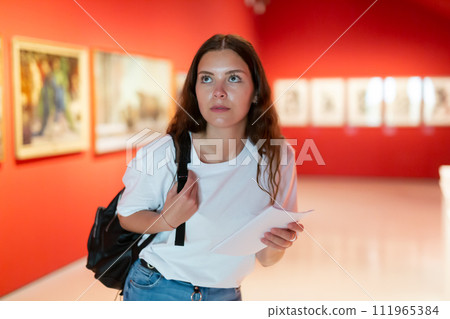 Portrait of a young girl visitor on at the exhibition of paintings in the museum Portrait of a young girl visitor on at the exhibition of paintings in the museum 111965384