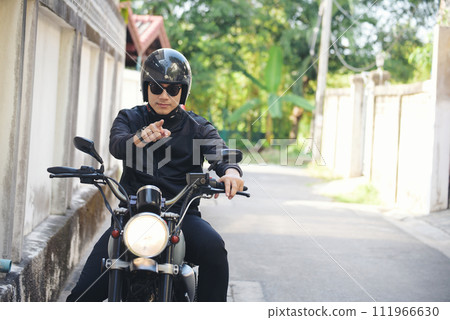 Asian man motorbike in black leather jacket travel rider trip. Handsome Men wear sunglass outdoor lifestyle freedom rider. Men trendy hipster cool person. Young asian man hobby ride with motor bike Asian man motorbike in black leather jacket travel rider trip. Handsome Men wear sunglass outdoor lifestyle freedom rider. Men trendy hipster cool person. Young asian man hobby ride with motor bike 111966630