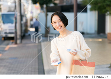 A woman handing out pocket tissues on the street A woman handing out pocket tissues on the street 111966723
