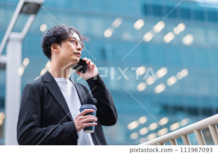 Businessman calling on smartphone in office area 111967093