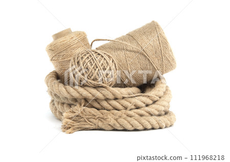 Rolls of natural jute rope and twine isolated on white Rolls of natural jute rope and twine isolated on white 111968218