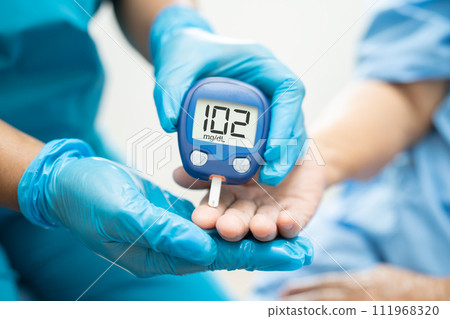 Doctor check diabetes from finger blood sugar level with finger lancet. Doctor check diabetes from finger blood sugar level with finger lancet. 111968320