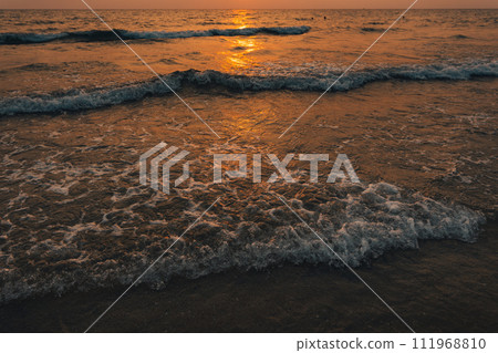 Sunset on the beach,Golden sea waves at sunset 111968810