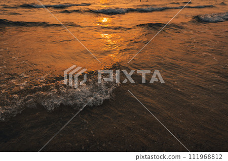 Sunset on the beach,Golden sea waves at sunset Sunset on the beach,Golden sea waves at sunset 111968812