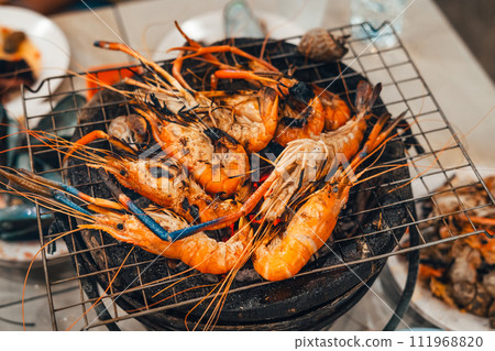 Shrimp grilled in a charcoal grill at a street food Shrimp grilled in a charcoal grill at a street food 111968820