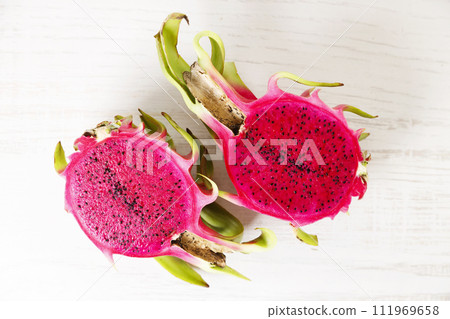 Red dragon fruit on white wooden background. Red dragon fruit on white wooden background. 111969658