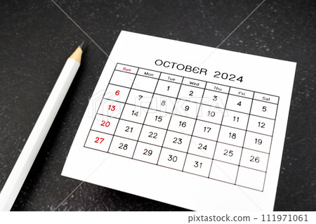 White calendar page for October 2024 and pencil. 111971061