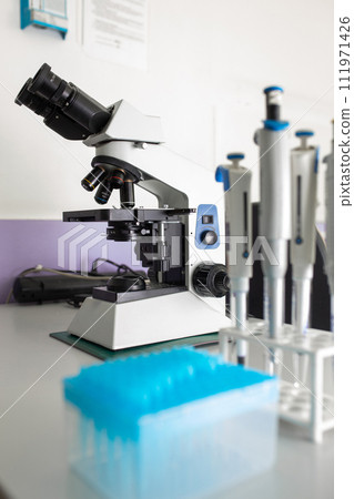 Microscope on the table in the laboratory, the technology of scientific research Microscope on the table in the laboratory, the technology of scientific research 111971426