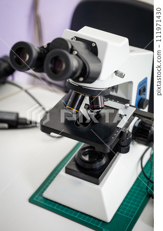 Microscope on the table in the laboratory, the technology of scientific research Microscope on the table in the laboratory, the technology of scientific research 111971430