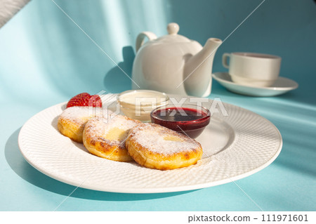 Delicious Breakfast of Cottage Cheese Pancakes with Fresh Strawberries and Sour Cream Delicious Breakfast of Cottage Cheese Pancakes with Fresh Strawberries and Sour Cream 111971601