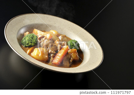 A photo of piping hot beef stew with many ingredients such as broccoli, carrots, and shimeji mushrooms against a black background. A photo of piping hot beef stew with many ingredients such as broccoli, carrots, and shimeji mushrooms against a black background. 111971797