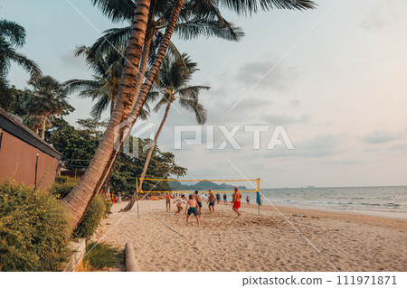 People playing volleyball on the beach in the evening 111971871