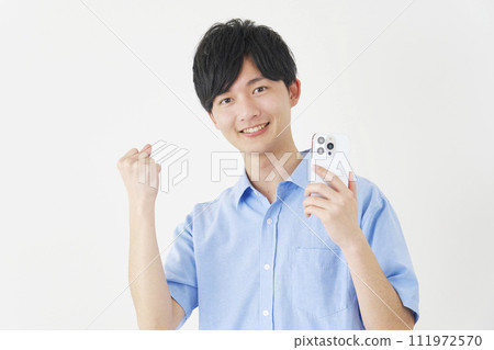 A man holding a smartphone and doing a fist pump, white background 111972570