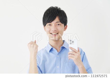 A man holding a smartphone and doing a fist pump, white background 111972571