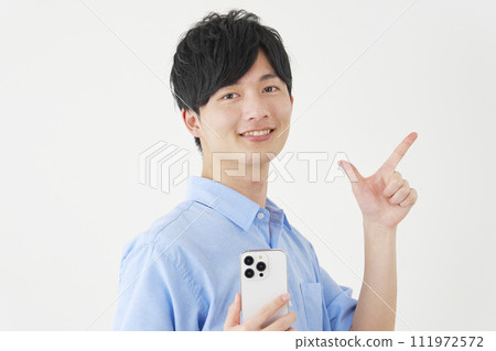 A man holding a smartphone and signing a check, white background 111972572