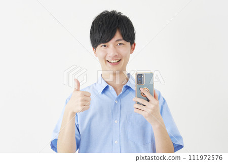 A man holding a smartphone and giving a good sign, white background 111972576