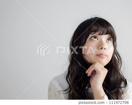 一幅亞洲女性的自然肖像，捕捉瞬間的思考。 111972706